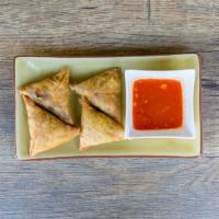 Samosa · Wheat flour wrap filled with potatoes, garlic, red onions, peas, unique spices, served with ...