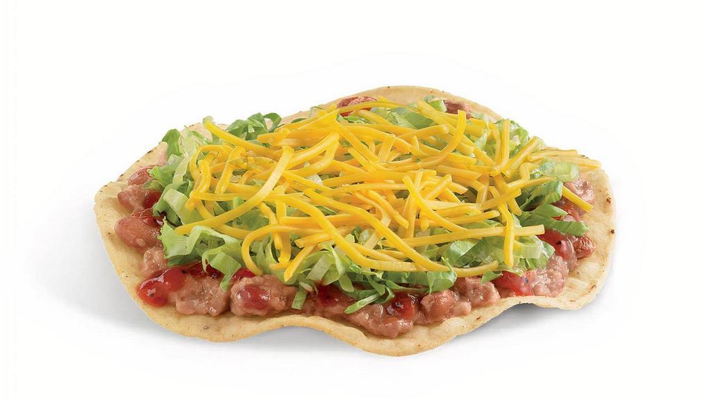 Crunchtada® Tostada · The original Crunchtada®! A thick, wavy, crunchy corn shell layered with slow-cooked beans made from scratch, signature tangy Salsa Casera, crisp shredded lettuce, and freshly grated cheddar cheese.
