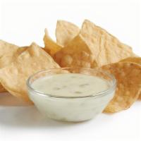Chips & Queso (Snack) · Signature creamy Queso Blanco served with fresh house-made tortilla chips.