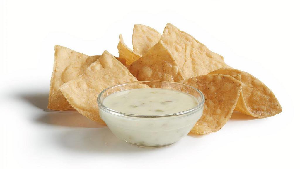 Chips & Queso (Snack) · Signature creamy Queso Blanco served with fresh house-made tortilla chips.