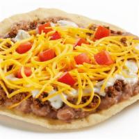 Queso Beef Crunchtada® · A thick, wavy, crunchy corn shell layered with slow-cooked beans made from scratch, seasoned...