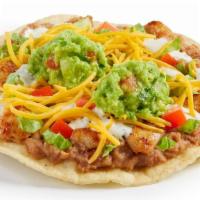 Chicken Guacamole Crunchtada® · A thick, wavy, crunchy corn shell layered with slow-cooked beans made from scratch, freshly ...