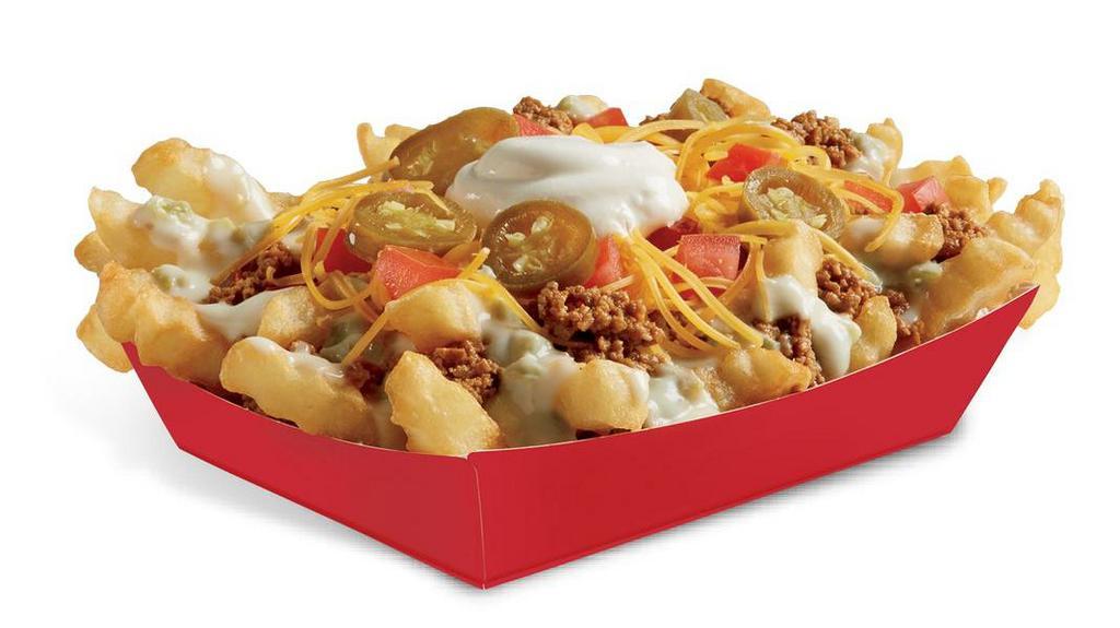 Queso Loaded Fries · Crinkle Cut Fries topped with seasoned beef, signature creamy Queso Blanco, freshly grated cheddar cheese, fresh diced tomatoes, cool sour cream and sliced jalapeños.