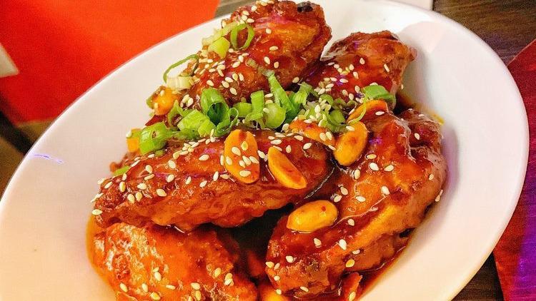 3. Korean Fried Chicken Wings with Sweet & Sour Spicy Sauce. · Battered and deep fried chicken wings tossed in sweet and spicy Korean sauce. Contains peanuts. 5 pieces.