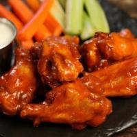Classic Buffalo · 8 traditional wings tossed in classic buffalo sauce (medium heat), served with carrots & cel...
