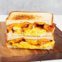 Breakfast Melt · Griddled sandwich with fried egg, melted yellow cheddar cheese, turkey bacon, and your choic...