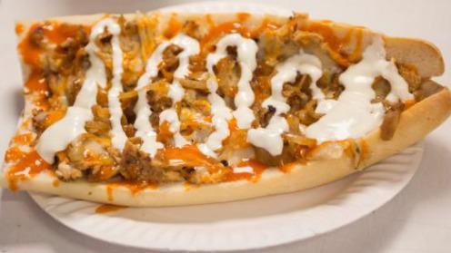 Buffalo Philly Chicken Sandwich · Thinly sliced chicken breast coated in buffalo sauce, smothered in melted white American cheese and mayo. Piled into a hoagie roll.