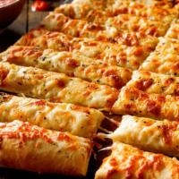 Cheesy Breadsticks · Hand-Stretched Dough, Shredded Mozzarella and Cheddar Cheese with Side of Marinara Sauce.