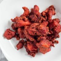 Chicken 65 · a spicy yet irresistibly delicious snack prepared by deep-frying spicy paste coated chunks o...