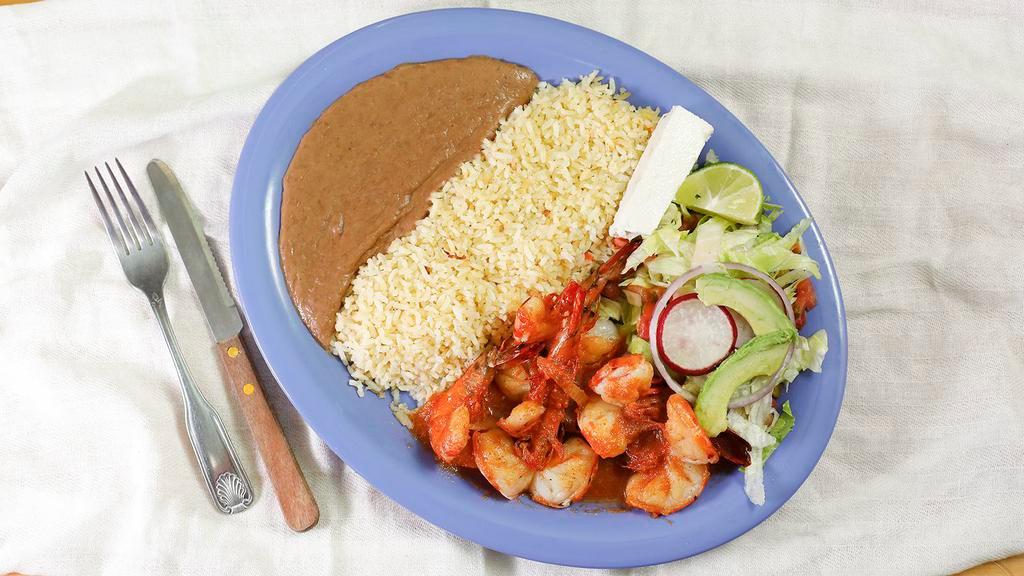 Camarones Rancheros  · Shrimp in ranchero sauce, served with rice, beans, avocado, salad, corn tortillas and a side of French Fries.