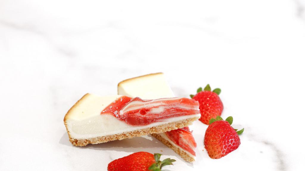 Strawberry Swirl Cheesecake · 2 mini slices of cheesecake with strawberry swirls and graham cracker crust.
