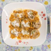 Mantu · A beef dumpling dish filled with ground beef, onion, and cilantro. Topped with lentil sauce,...