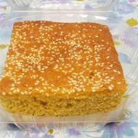 Corn Cake · A cake made out of corn flour topped with sesame seeds, similar to corn bread. Features milk...