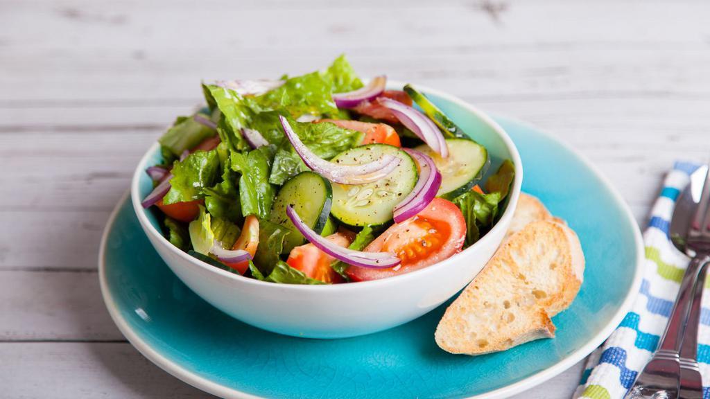 Garden Salad · Fresh salad made with fresh cut lettuce, tomato, cucumber, onion, mixed greens and salad dressing.