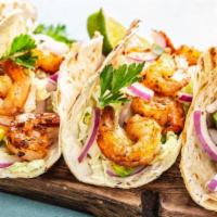 Shrimp Taco · Enticing shrimp taco with grilled shrimp and pineapple salsa, served with cabbage and chipot...