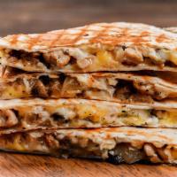 The Carnitas Quesadilla · Freshly prepared, warm flour tortilla filled with perfectly seasoned pulled pork, gooey Mont...