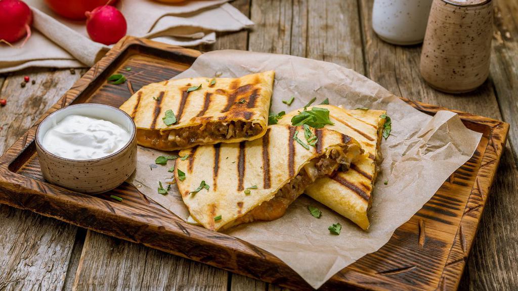 The Steak Quesadilla · Freshly prepared, warm flour tortilla filled with perfectly seasoned steak strips, gooey Monterey jack cheese and salsa fresca. Served with a side of sour cream and guacamole.