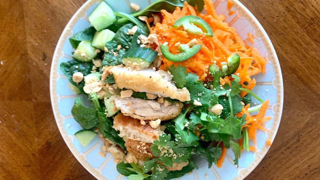 Thai Salad · Shredded carrots, cucumber, cilantro, jalapenos, and peanuts.