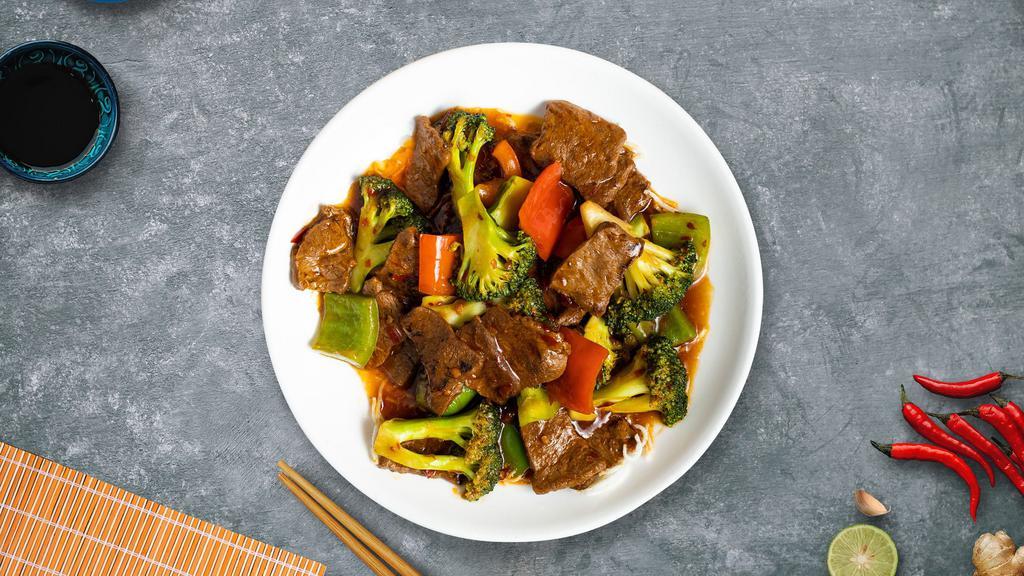 Munchy Mongolian Beef · Sliced beef stir-fried with white and green onions in a Mongolian sauce over a bed of crisp rice noodles