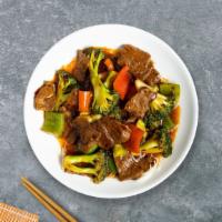 Being Beijing Beef · Stir-fried beef with broccoli, peppers, and onion in a house tangy sweet and spicy sauce