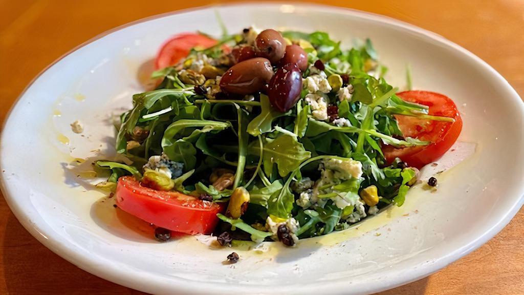 Servizio Di Sportivo · With arugula, pistachio, currants, crumbled blue cheese, and sicilian green olives. Served with extra virgin olive oil and vinegar dressing.