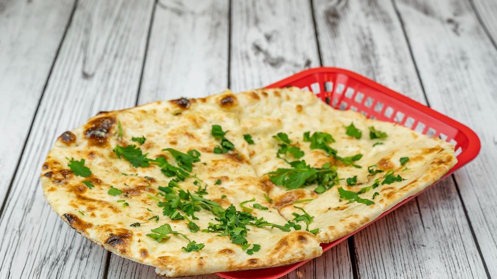 Garlic Naan · Naan topped with chopped garlic and cilantro.