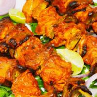 Chicken Tikka Kebab · Boneless marinated chicken cubes cooked in a clay oven.