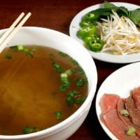 Pho-Ha-Noi Beef Noodle Soup · North Vietnamese delight. Rice noodles, beef, basil, chilies, lemon and bean sprouts. In a b...