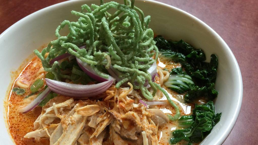 Kao Soi (Noodle Curry) · Egg noodles in a spicy/creamy coconut sauce with chicken, bok choy, red onions, and topped with crispy jade noodles.