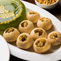 Delhi Pani Puri · Hollow puffed puns stuffed with spicy garbanzo beans and boiled potatoes, served with a spic...