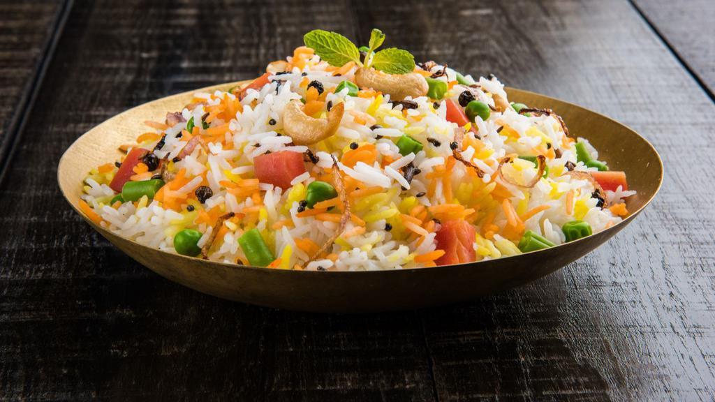 Vegetable Biryani · Farmer's market fresh vegetables marinated in Indian spices on a bed of basmati rice.