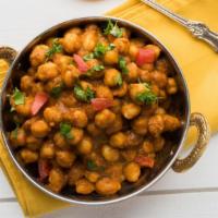 The Channa Masala · Chickpeas Cooked In Exotic Blend Of Indian Spices. Served with Basmati Rice.