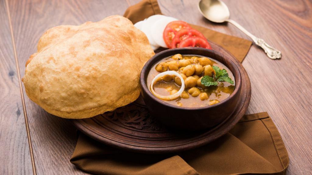 Chole Bhature · Classic Punjabi dish made with garbanzo beans. Served with fried Indian Puri (bread).