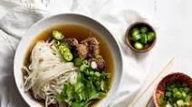 Meatball Pho · Beef meatballs in beef broth garnished with onion, scallion, cilantro, and a side of bean sp...