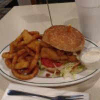 Fish Sandwich · Served with tartar sauce, lettuce, tomatoes, and pickles on a sesame seed bun.