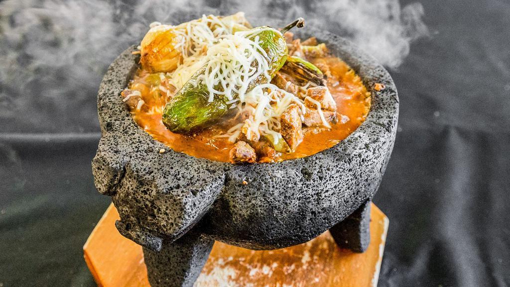 Molcajete · Serves two. Grilled chicken and steak, grilled cactus, chorizo, in our molcajete salsa. Served with handmade corn tortillas, rice, and beans.