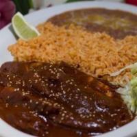 Mole con Pollo · Chicken in a rich mole sauce. Served with rice, beans, and tortillas.