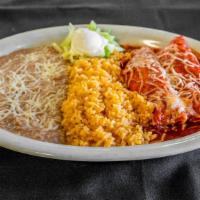 Enchiladas Mexicanas · Two pieces. Chicken or beef enchiladas in our red sauce. Served with lettuce, sour cream, ri...