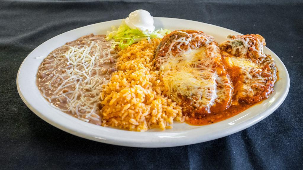 Chile Relleno · Two pieces. Pasilla pepper stuffed with cheese and topped with tomato sauce. Served with rice, beans, and tortillas.