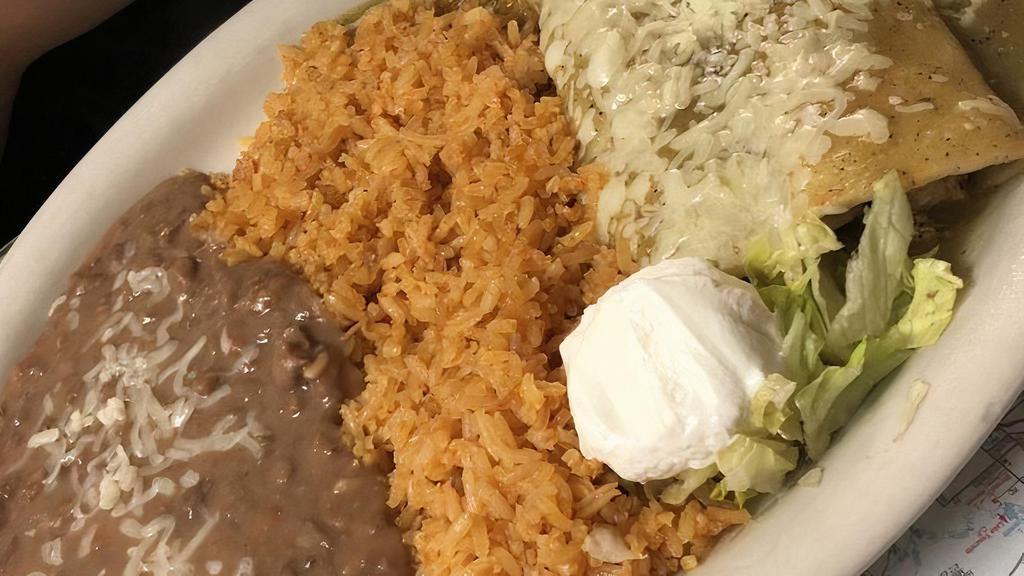 Salsa Verde Enchiladas · Two pieces. Chicken enchiladas in our salsa verde. Served with lettuce, sour cream, rice, and beans.