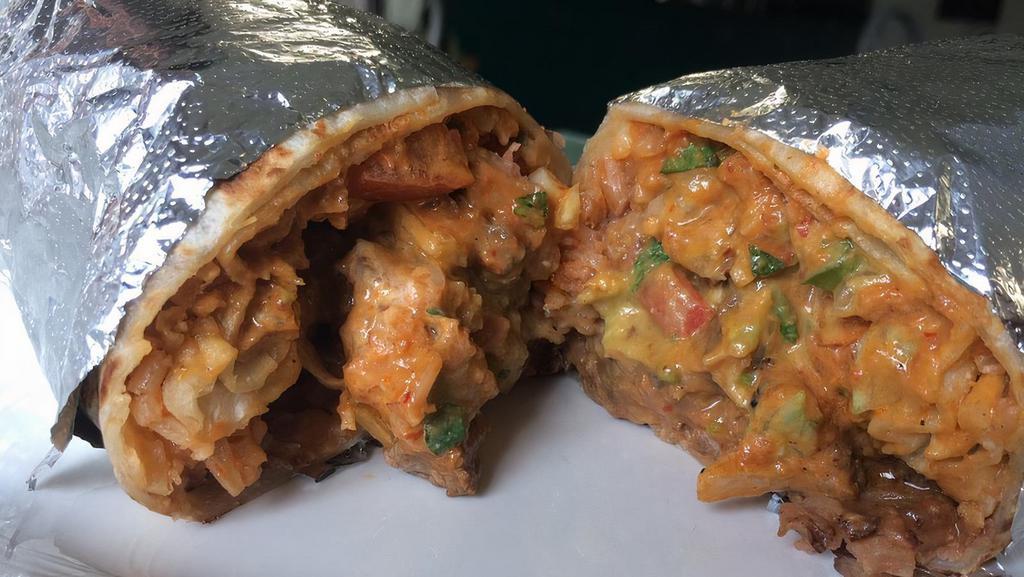 Super Burrito · Choice of meat, beans, rice, Monterey Jack cheese, lettuce, sour cream, guacamole, pico de gallo, and mild salsa.