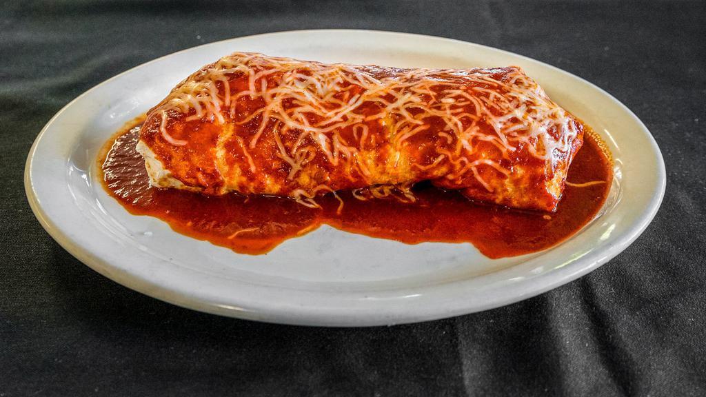 Wet Burrito · Choice of meat, beans, rice, Monterey Jack cheese, sour cream, and guacamole, covered with red sauce or salsa verde.