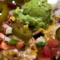 Nachos · Tortilla chips topped with Monterey Jack cheese, beans, jalapeños, sour cream, and pico de g...