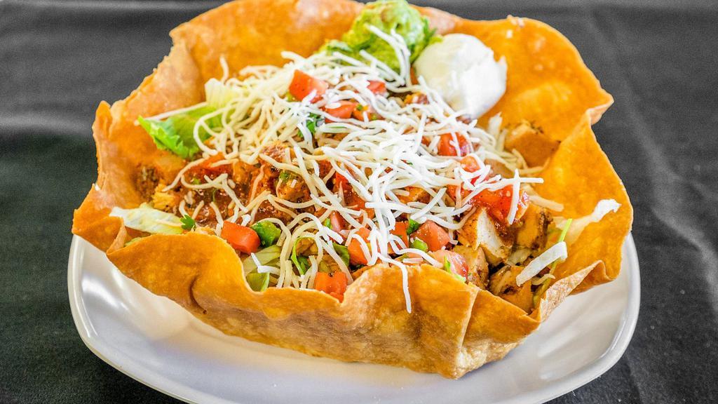 Taco Salad · Tortilla shell with your choice of meat, lettuce, black beans, rice, Monterey Jack cheese, sour cream, guacamole, and pico de gallo.