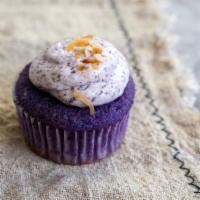Ube Macapuno (Regular Size) · Ube coconut cake topped with ube buttercream frosting, and garnished with toasted coconut fl...