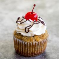Banana Split (Mini Size) · Banana cake frosted with vanilla buttercream, garnished with chocolate drizzles and topped o...