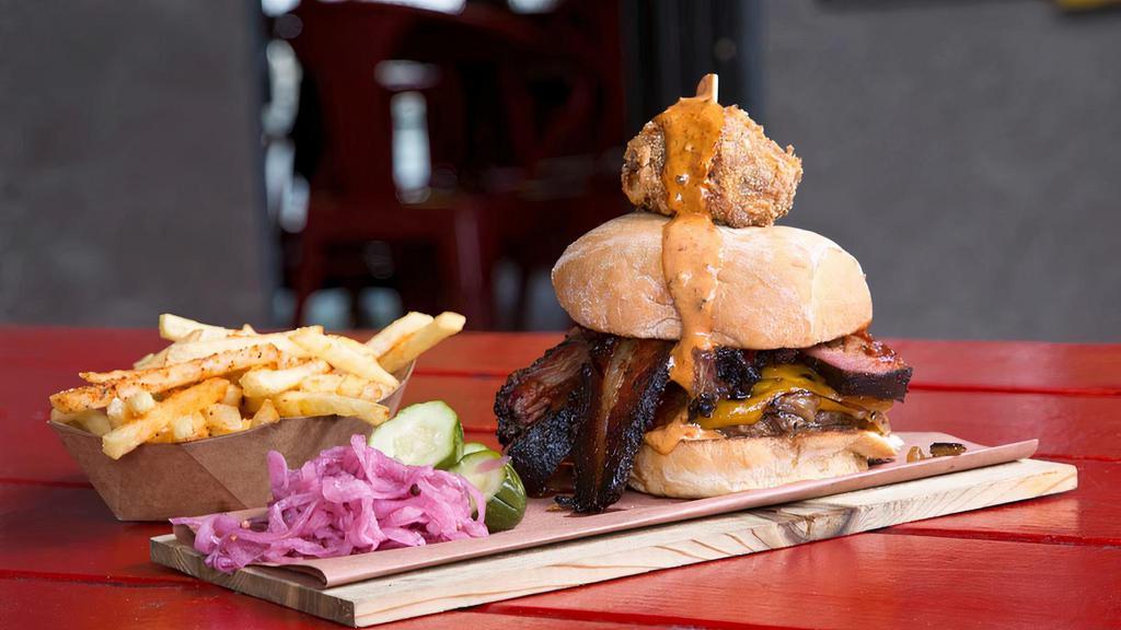 WTF Burger · Painted Hills ground beef, grilled onions, white cheddar, BBQ pork shoulder, 14-hour prime brisket, house-cured maple bacon, topped with a fried chipoltle pork cake. Served with killer fries