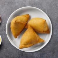Samosa · (8 pieces) Idaho potatoes mixed in a curry marinate & fried in a crispy wheat layer.
