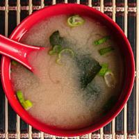 Miso Soup · Traditional japanese soy bean soup garnished with tofu and green onions.