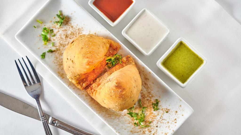 Veggie Samosa (2 Pieces) · Crispy turnover stuffed with potatoes, green peas, spinach, and fresh Indian spices.